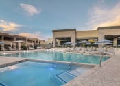 Thumbnail 30 of 39 - a resort style pool with lounge chairs and umbrellas