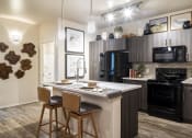 Thumbnail 4 of 39 - a kitchen with a large center island with two stools