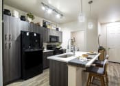 Thumbnail 5 of 39 - a kitchen with a large island and black appliances