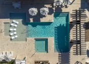 Thumbnail 47 of 51 - an aerial view of a pool and umbrellas on the side of a building