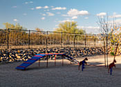 Thumbnail 57 of 58 - A playground with a blue slide and red climbing frame.