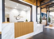 Thumbnail 37 of 51 - a reception area with a marble reception desk and a logo