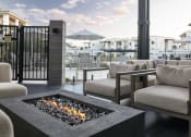 Thumbnail 45 of 51 - a patio with couches and chairs and a fire pit