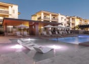 Thumbnail 50 of 51 - a swimming pool at a resort with chairs and umbrellas