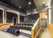 Thumbnail 41 of 51 - a large auditorium with a row of seats and a table and chairs in front