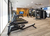 Thumbnail 4 of 51 - a gym with treadmills and other exercise equipment in a room with a window