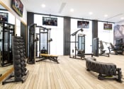 Thumbnail 38 of 51 - a gym with weights and cardio equipment on the floor and a wall of windows