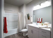 Thumbnail 24 of 51 - a bathroom with a shower toilet and sink and a mirror