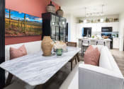 Thumbnail 21 of 51 - a living room with a dining room table and a kitchen