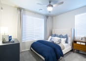 Thumbnail 10 of 51 - a bedroom with a bed and a ceiling fan