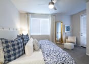Thumbnail 12 of 51 - a bedroom with a large bed and a ceiling fan