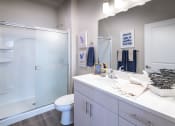Thumbnail 11 of 51 - a bathroom with a shower and a sink and a toilet