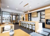 Thumbnail 44 of 51 - a kitchen and dining area with a bar and a table with chairs