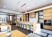 Thumbnail 6 of 51 - a kitchen and dining area with a bar and a table with chairs
