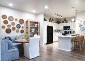 Thumbnail 9 of 51 - a living room and kitchen with a table and chairs