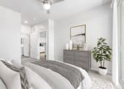 Thumbnail 34 of 51 - a bedroom with a large bed and a dresser with a plant on it
