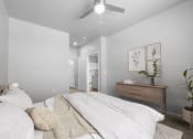 Thumbnail 29 of 51 - a bedroom with a large bed and a ceiling fan