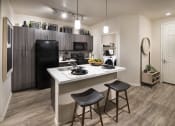 Thumbnail 23 of 23 - a kitchen with a large island and a black refrigerator
