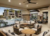 Thumbnail 12 of 23 - a lobby with couches and tables and a swimming pool