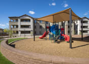Thumbnail 5 of 23 - a playground with a tent and slides in front of an apartment complex