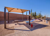 Thumbnail 6 of 23 - a playground with a fire hydrant and picnic tables