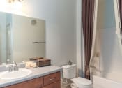 Thumbnail 42 of 51 - a bathroom with a toilet sink and bathtub
