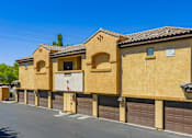 Thumbnail 24 of 24 - A row of tan stucco houses with garage doors.