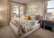 Thumbnail 7 of 14 - A bedroom with a large bed and a window with curtains.