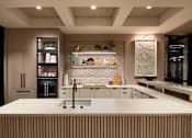 Thumbnail 3 of 34 - A modern kitchen with a large island and wooden accents.