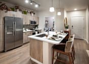 Thumbnail 13 of 34 - A modern kitchen with a dining table set for four.
