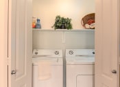 Thumbnail 47 of 51 - a small laundry room with a washer and dryer