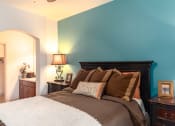 Thumbnail 44 of 51 - a bedroom with a bed and a nightstand with a lamp