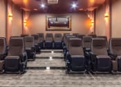 Thumbnail 34 of 51 - a large auditorium with chairs and a projector screen