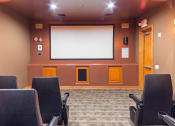 Thumbnail 35 of 51 - a room with chairs and a large screen on the wall