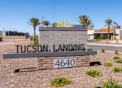 Thumbnail 1 of 56 - A sign that says Tucson Landing 4640 in front of some buildings.