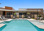Thumbnail 4 of 56 - A swimming pool in front of a house with a fence around it.