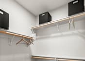 Thumbnail 39 of 56 - A room with a white wall and a wooden floor with two shelves and two black boxes.