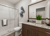 Thumbnail 55 of 56 - A bathroom with a toilet, sink, and shower.