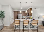 Thumbnail 44 of 56 - A modern kitchen with a dining table set for two.