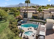Thumbnail 24 of 51 - A pool and patio area with a mountain in the background.