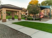 Thumbnail 48 of 51 - a park with a playground and gazebo at the whispering winds apartments in pearland