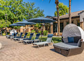 Thumbnail 5 of 24 - A row of lounge chairs are arranged on a patio.