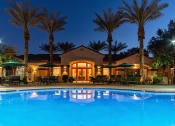 Thumbnail 1 of 51 - a resort style swimming pool with lounge chairs and umbrellas at night