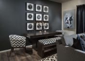 Thumbnail 17 of 29 - a living room with a table and chairs and pictures on the wall