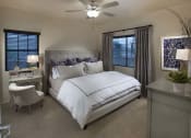 Thumbnail 25 of 29 - a bedroom with a bed and a ceiling fan