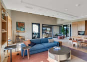 Thumbnail 44 of 53 - a living room and dining room with a blue couch and a table