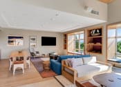 Thumbnail 45 of 53 - a living room with a blue couch and a wooden table