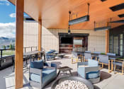 Thumbnail 37 of 53 - a lounge area with chairs and tables and a television