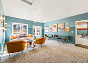 Thumbnail 9 of 34 - a living room with blue walls and a couch and chairs