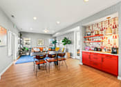 Thumbnail 12 of 34 - a dining room with a table and chairs and a living room